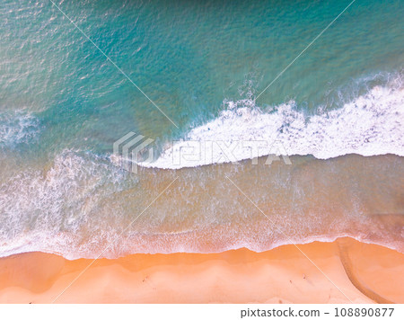Aerial view of Waves crashing on sandy shore,Sea surface ocean waves background,Top view beach background Aerial view of Waves crashing on sandy shore,Sea surface ocean waves background,Top view beach background 108890877