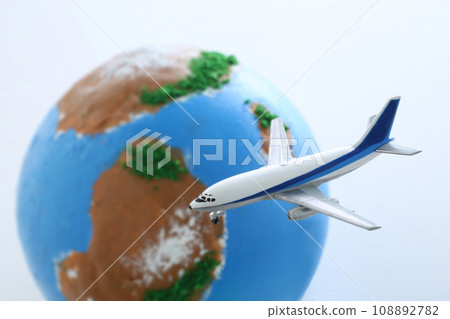 A model of an airplane floating above a globe A model of an airplane floating above a globe 108892782