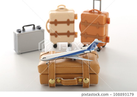Suitcase and airplane model for a trip 108893179