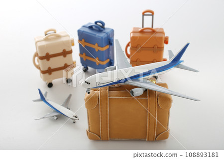 Suitcase and airplane model for a trip Suitcase and airplane model for a trip 108893181