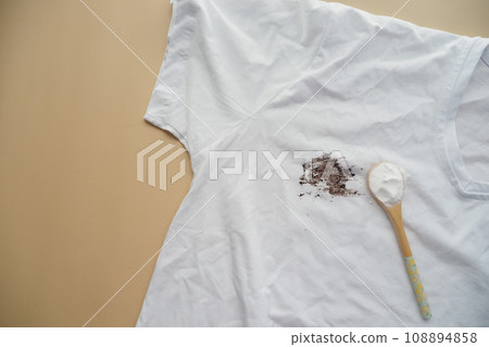removing stain on clothes with biocarbonat. removing stain on clothes with biocarbonat. 108894858
