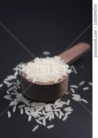 Raw white rice on a wooden spoon Raw white rice on a wooden spoon 108894859
