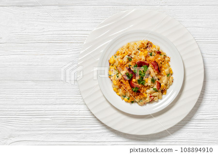 portion of macaroni and cheese with corn, bacon topped with panko breadcrumbs on white plate portion of macaroni and cheese with corn, bacon topped with panko breadcrumbs on white plate 108894910