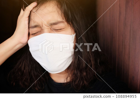 Asian Thai woman wearing a black cloth mask for prevent the Covid-19 or Corona virus and Epidemic disease at Thailand and around the world. She is serious and headache. Health and illness concept Asian Thai woman wearing a black cloth mask for prevent the Covid-19 or Corona virus and Epidemic disease at Thailand and around the world. She is serious and headache. Health and illness concept 108894955