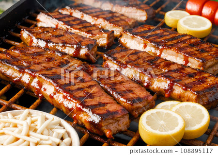 Juicy beef hamburger patties on barbecue grill. Barbecue Grill Pit With Glowing And Flaming Hot Charcoal Juicy beef hamburger patties on barbecue grill. Barbecue Grill Pit With Glowing And Flaming Hot Charcoal 108895117