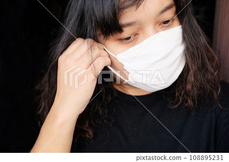 Asian Thai woman wearing a white cloth mask for prevent the Covid-19 or Corona virus and Air Pollution Value Pm 2.5 in Thailand and Epidemic disease around the world. Health and illnes Asian Thai woman wearing a white cloth mask for prevent the Covid-19 or Corona virus and Air Pollution Value Pm 2.5 in Thailand and Epidemic disease around the world. Health and illnes 108895231