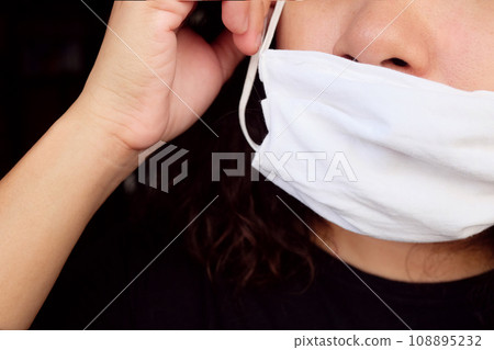 Asian Thai woman wearing a white cloth mask for prevent the Covid-19 or Corona virus and Air Pollution Value Pm 2.5 in Thailand and Epidemic disease around the world. Health and illnes Asian Thai woman wearing a white cloth mask for prevent the Covid-19 or Corona virus and Air Pollution Value Pm 2.5 in Thailand and Epidemic disease around the world. Health and illnes 108895232