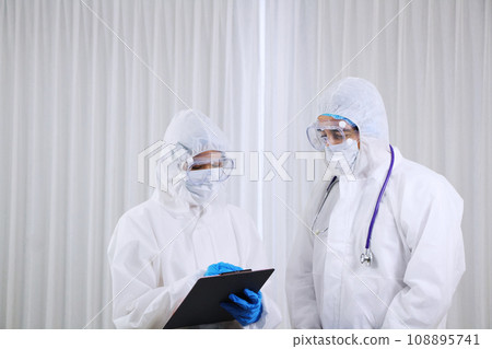 Medical team in Personal Protective Equipment or PPE clothing Researching and Discussing for patients infected with the Covid 19 virus and treatment in emergency and lab at hospital in Thailand Medical team in Personal Protective Equipment or PPE clothing Researching and Discussing for patients infected with the Covid 19 virus and treatment in emergency and lab at hospital in Thailand 108895741