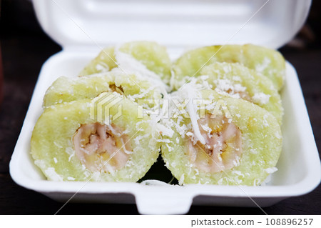 Thai sweet Dessert, Banana in steamed Sticky Rice pieces on white Foam box Thai sweet Dessert, Banana in steamed Sticky Rice pieces on white Foam box 108896257