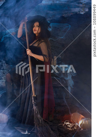 A portrait of a young sexy witch with outside. Magic, dark force, spell. Witchcraft. Halloween. A portrait of a young sexy witch with outside. Magic, dark force, spell. Witchcraft. Halloween. 108899449