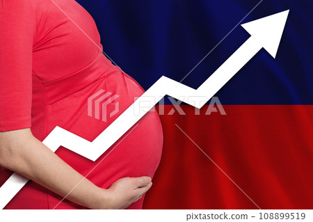 Haitian pregnant woman on flag of Haiti background. Birth rate up 108899519