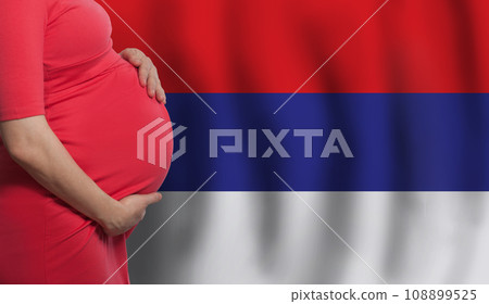 Pregnant woman belly on Serbian flag background Pregnant woman belly on Serbian flag background 108899525