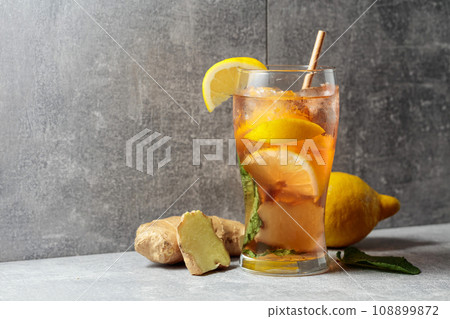 Iced tea with mint, ginger, and lemon on a grey background. 108899872