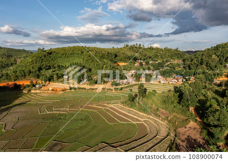 Aerial view of terraced agriculture field among greenery mountains with the blue cloudy and sunlight in the northern of Thailand, Omkoi district, Chiang Mai. Aerial view of terraced agriculture field among greenery mountains with the blue cloudy and sunlight in the northern of Thailand, Omkoi district, Chiang Mai. 108900074