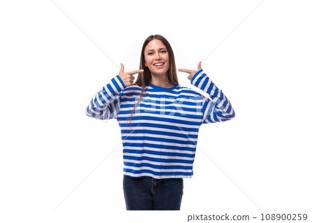 positive smiling young brunette woman in a striped blue blouse on a white background with copy space positive smiling young brunette woman in a striped blue blouse on a white background with copy space 108900259