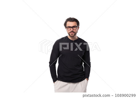 handsome young brunette man with a beard put on glasses for vision correction handsome young brunette man with a beard put on glasses for vision correction 108900299