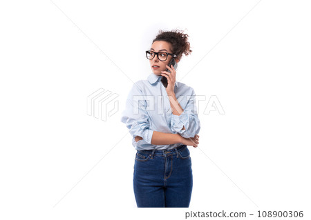 beautiful young stylish caucasian office worker woman with curly hair speaks on the phone 108900306