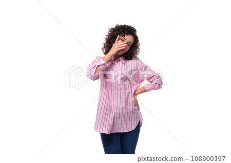 portrait of a young slender caucasian leader woman dressed in a pink striped oversized shirt 108900397