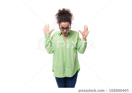 young stylish caucasian secretary woman with black curly hair in glasses and light green shirt on a 108900405