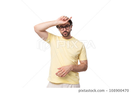 caucasian brutal charming guy with a beard dressed in a summer t-shirt on a white background with caucasian brutal charming guy with a beard dressed in a summer t-shirt on a white background with 108900470