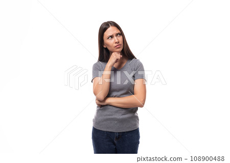 young well-groomed brunette woman in a gray t-shirt with a mock-up for an identity on a white 108900488