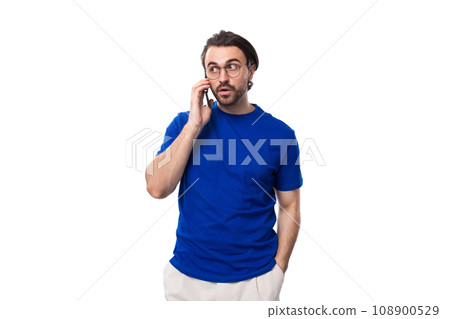 young brunette European man with a well-groomed beard speaks on the phone young brunette European man with a well-groomed beard speaks on the phone 108900529