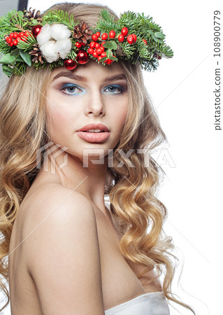 Pretty healthy young woman with party makeup, long blonde curly hairdo and Christmas decor 108900779