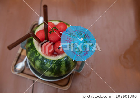 delicious watermelon smoothie in tropical fruit on wooden cafe table 108901396