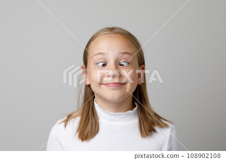Funny kid face. Adorable girl grimacing, portrait Funny kid face. Adorable girl grimacing, portrait 108902108