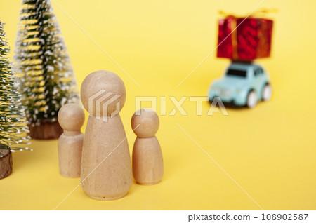 Mother, daughter, and son eagerly await their father return for Christmas with present 108902587