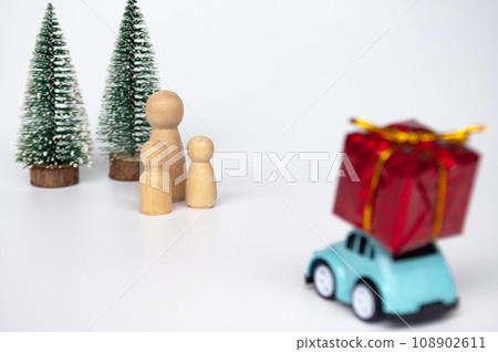 Toy car carry present while on a journey back home for Christmas. Christmas and holiday concept 108902611
