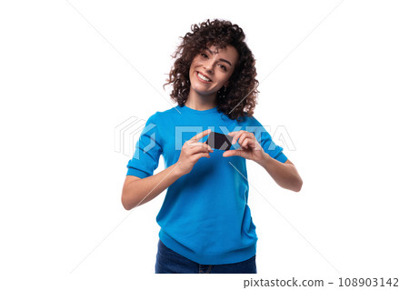 a young woman with a curly hairstyle above her shoulders shows a plastic card mockup a young woman with a curly hairstyle above her shoulders shows a plastic card mockup 108903142