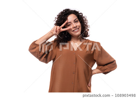 young curly businesswoman dressed in a brown blouse on a white background 108903498