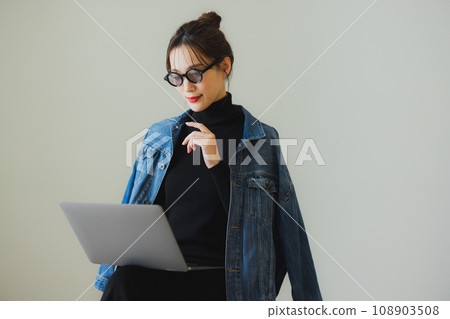 A woman using a computer A woman using a computer 108903508