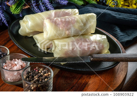 Cabbage rolls stuffed with meat and grits . 108903922