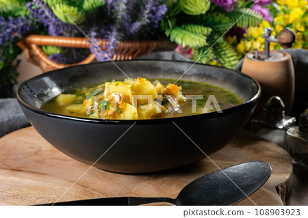 Cucumber soup in dark bowl. 108903923