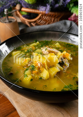 Cucumber soup in dark bowl. 108903924