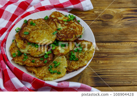 Potato pancakes on a wooden table Potato pancakes on a wooden table 108904428