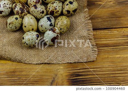 Quail eggs on a wooden table 108904460