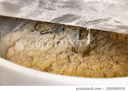 Making dough for bread in a kneader 108906059