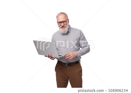 a successful grandfather with a white beard and mustache is dressed in a shirt and trousers working a successful grandfather with a white beard and mustache is dressed in a shirt and trousers working 108906234
