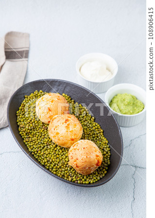cooked meatballs on peas in an oblong bowl cooked meatballs on peas in an oblong bowl 108906415