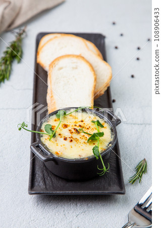 Julienne in a mug with pieces of bread 108906433