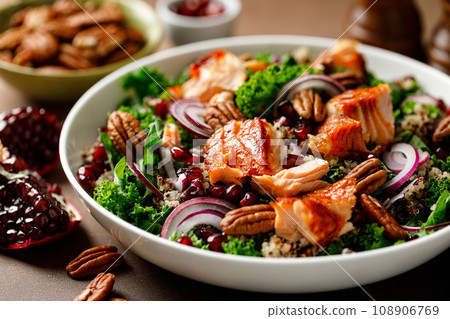 Salmon superfood salad with grilled fish, kale, quinoa, pecan nuts, red onion and pomegranate 108906769