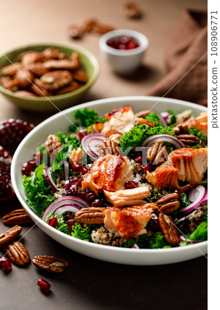 Salmon superfood salad with grilled fish, kale, quinoa, pecan nuts, red onion and pomegranate 108906771
