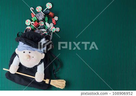 The Befana with sweet coal and candy. Italian Epiphany day tradition. 108906952