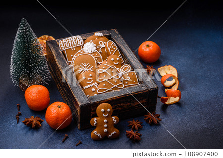 Beautiful festive Christmas composition of tangerines, gingerbread and star anise 108907400