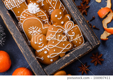 Beautiful festive Christmas composition of tangerines, gingerbread and star anise Beautiful festive Christmas composition of tangerines, gingerbread and star anise 108907411
