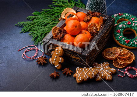 Beautiful festive Christmas composition of tangerines, gingerbread and star anise 108907417