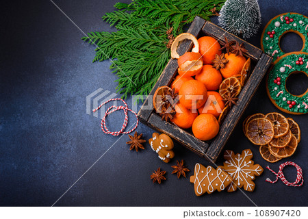Beautiful festive Christmas composition of tangerines, gingerbread and star anise 108907420